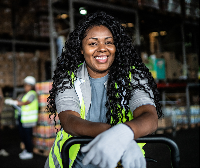 Woman working in manufacturing smiling