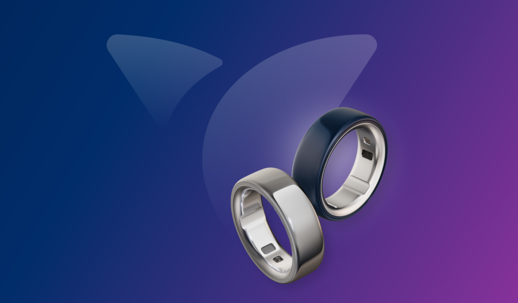 Two sleek smart rings—Oura Ring devices in silver and dark blue—float against a purple-to-blue gradient background, alongside the Vida Health logo, with a small analytics icon suggesting health and activity tracking.